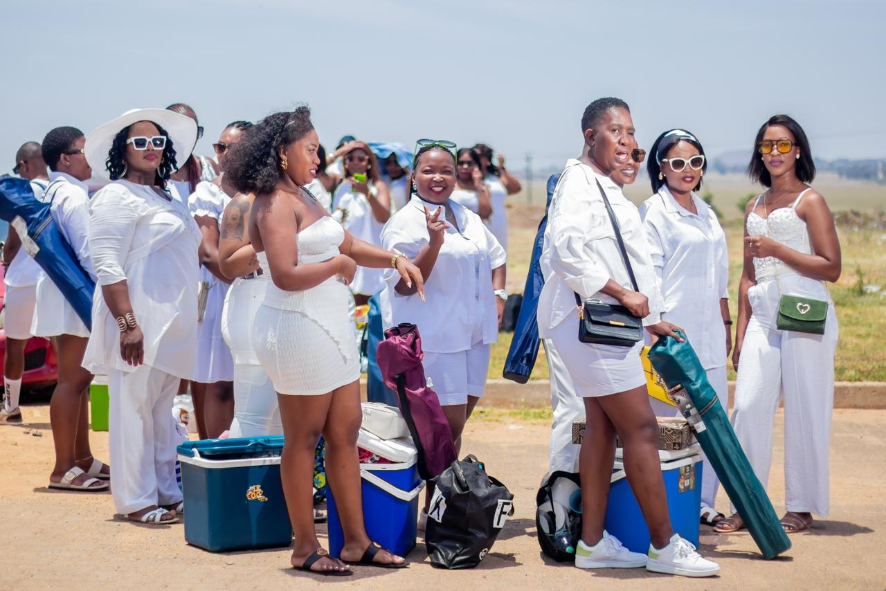December 2024 - Attendees in white outfits at outdoor venue